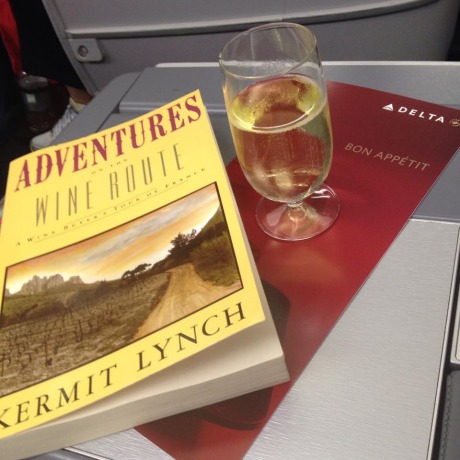 Flight from Atlanta to Paris with a glass of Champagne, of course! And an excellent book detailing importer Kermit Lynch and his travels around wine country in France - a must-read to prepare for the journey.